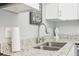 Close up on a kitchen sink with granite countertops and modern faucet at 219 N Rossiter St, Mount Dora, FL 32757