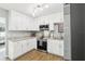 Bright kitchen with modern appliances, granite countertops and white cabinets at 219 N Rossiter St, Mount Dora, FL 32757