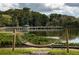 Relaxing lakeside park with a hammock and boardwalk, perfect for enjoying nature and outdoor activities at 219 N Rossiter St, Mount Dora, FL 32757