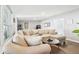 Cozy living room with a large sectional sofa and wood flooring at 219 N Rossiter St, Mount Dora, FL 32757