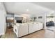 Spacious living room with a modern fireplace, large sectional, and natural light at 219 N Rossiter St, Mount Dora, FL 32757
