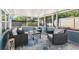 Inviting screened porch with comfortable seating, a coffee table and a patterned rug at 219 N Rossiter St, Mount Dora, FL 32757