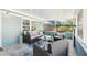 Comfortable screened porch with an outdoor sofa, chairs, and light blue decor at 219 N Rossiter St, Mount Dora, FL 32757