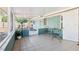 Screened in porch with tile floors, a small table and chairs at 219 N Rossiter St, Mount Dora, FL 32757