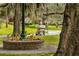Picturesque street scene featuring a golf cart and lush trees with Spanish moss at 219 N Rossiter St, Mount Dora, FL 32757