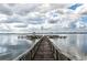 Scenic wooden pier extending into a serene lake, ideal for fishing or enjoying the peaceful water views at 219 N Rossiter St, Mount Dora, FL 32757
