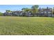 Backyard area of townhomes with a large green lawn and trees at 2210 Stonington Ave # 2210, Orlando, FL 32817