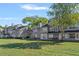 Spacious backyard of a condo complex, showcasing lush green lawns and mature trees at 2210 Stonington Ave # 2210, Orlando, FL 32817