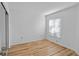 Bright bedroom featuring wood floors, white walls, and a window with blinds at 2210 Stonington Ave # 2210, Orlando, FL 32817