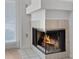Fireplace featuring neutral tile surround and glass enclosure at 2210 Stonington Ave # 2210, Orlando, FL 32817