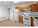 Kitchen featuring wood cabinets, granite countertops, and white appliances at 2210 Stonington Ave # 2210, Orlando, FL 32817