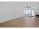 Open-concept living room with wood floors, fireplace, and abundant natural light at 2210 Stonington Ave # 2210, Orlando, FL 32817