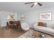 Sunlit living room with modern furniture, ceiling fan, and laminate flooring at 2210 Stonington Ave # 2210, Orlando, FL 32817