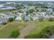 Expansive aerial view of a residential community with lush green lawns and serene lakes in the background at 22247 Draw Bridge Dr, Leesburg, FL 34748