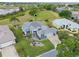 Aerial view of home showcasing mature landscaping, backyard and proximity to green spaces at 22247 Draw Bridge Dr, Leesburg, FL 34748