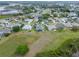 Expansive aerial view of a residential community with lush green lawns and serene lakes in the background at 22247 Draw Bridge Dr, Leesburg, FL 34748