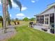 Well-maintained backyard with a patio, grill, and lush landscaping at 22247 Draw Bridge Dr, Leesburg, FL 34748