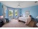 Comfortable bedroom with bay windows and natural light, two armchairs and a ceiling fan at 22247 Draw Bridge Dr, Leesburg, FL 34748