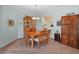 Dining room featuring a wooden table with six chairs and an open view to the kitchen and living spaces at 22247 Draw Bridge Dr, Leesburg, FL 34748
