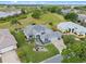 Stunning home with lush landscaping, well-manicured lawn, and serene water views offers curb appeal at 22247 Draw Bridge Dr, Leesburg, FL 34748