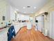 Bright kitchen with white cabinetry, an island, hardwood floors, and a breakfast nook at 22247 Draw Bridge Dr, Leesburg, FL 34748