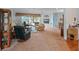 Spacious living room with carpet, a ceiling fan, pool table, access to outdoor living and an open floor plan at 22247 Draw Bridge Dr, Leesburg, FL 34748