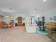 Spacious living room with carpet, a ceiling fan, an open floor plan, and a view to dining and outdoor living spaces at 22247 Draw Bridge Dr, Leesburg, FL 34748
