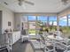 Bright sunroom featuring a dining area, sink and a view of the landscaped backyard at 22247 Draw Bridge Dr, Leesburg, FL 34748