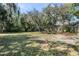 Large grassy yard with trees and a trailer, great for outdoor recreation and storage at 234 S Central Ave, Apopka, FL 32703
