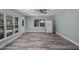 Bright living area featuring stylish gray wood floors, recessed lighting, and large windows providing natural light at 234 S Central Ave, Apopka, FL 32703