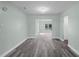 Spacious living room featuring wood-look floors, white trim and neutral paint at 234 S Central Ave, Apopka, FL 32703