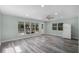 Bright living area featuring stylish gray wood floors, recessed lighting, and large windows providing natural light at 234 S Central Ave, Apopka, FL 32703