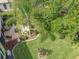 Aerial view of the property showcasing lush landscaping, a well-maintained lawn, and an inviting outdoor patio at 24112 Robinwood St, Leesburg, FL 34748
