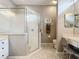 This bathroom features a glass enclosed shower with a vanity and seated makeup area at 24112 Robinwood St, Leesburg, FL 34748