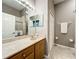 Bathroom showcasing a vanity with a marble countertop, double mirrors, and decorative light fixture at 24112 Robinwood St, Leesburg, FL 34748