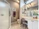 Bathroom with a glass door shower, vanity, and tiled floor at 24112 Robinwood St, Leesburg, FL 34748