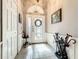 Elegant foyer with tile flooring, wainscoting, and decorative front door with glass detailing at 24112 Robinwood St, Leesburg, FL 34748