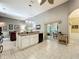 Bright kitchen with a view to the living and dining area with an island and granite countertops at 24112 Robinwood St, Leesburg, FL 34748