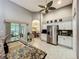 Bright, open kitchen with granite countertops, stainless steel refrigerator, and tile flooring at 24112 Robinwood St, Leesburg, FL 34748