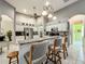 Spacious kitchen with granite countertops, white cabinets, stainless steel appliances, and an island with seating at 24112 Robinwood St, Leesburg, FL 34748