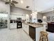 Spacious kitchen features white cabinets, granite countertops, and modern black appliances at 24112 Robinwood St, Leesburg, FL 34748