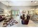 Spacious living area offers a view of the patio and bar seating into the kitchen at 24112 Robinwood St, Leesburg, FL 34748
