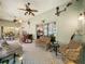 Inviting sunroom featuring casual seating, ceiling fans, and bar area with access to the kitchen at 24112 Robinwood St, Leesburg, FL 34748