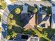 This aerial view shows mature landscaping, manicured lawns, and private driveways within a quiet neighborhood at 2428 Maverick Way, The Villages, FL 32162