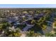 High aerial of a mature neighborhood with tree-lined streets, well-maintained landscaping, and community charm at 2428 Maverick Way, The Villages, FL 32162