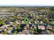 Aerial shot of a home with well-kept lawns and mature landscaping in a tranquil, established neighborhood setting at 2428 Maverick Way, The Villages, FL 32162