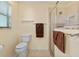 Bathroom featuring a toilet and glass enclosed shower, with neutral color palette at 2428 Maverick Way, The Villages, FL 32162