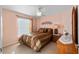 Cozy bedroom with a comfortable bed, side table, and a window for natural light at 2428 Maverick Way, The Villages, FL 32162