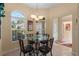 Breakfast nook with glass top table with chandelier lighting at 2428 Maverick Way, The Villages, FL 32162