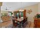 Dining room with hardwood floors, chandelier, and open to the living room at 2428 Maverick Way, The Villages, FL 32162